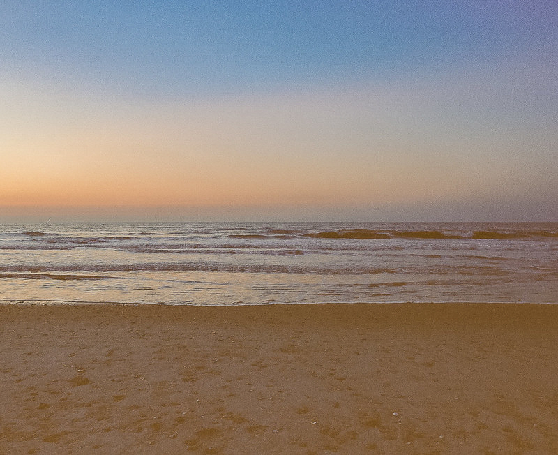 Beach at sunset with gentle waves — 55mm f/4, Portra 160